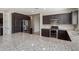 Open-concept kitchen featuring stainless steel appliances and a large center island with granite countertop at 20644 W Mariposa St, Buckeye, AZ 85396