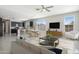 Bright, open-concept living room featuring a modern kitchen, dining area, and comfortable seating arrangement at 20644 W Mariposa St, Buckeye, AZ 85396
