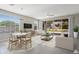 Inviting living room with a dining area, large windows, and sliding glass doors to outdoor area at 20644 W Mariposa St, Buckeye, AZ 85396