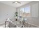 Bright office space featuring a modern glass desk, comfortable chairs, and natural light from the large window at 20644 W Mariposa St, Buckeye, AZ 85396