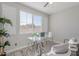 Well-lit home office with a glass desk, plush chairs, and stylish decor creating a productive workspace at 20644 W Mariposa St, Buckeye, AZ 85396
