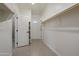 Spacious walk-in closet with built-in shelving and racks and connecting rooms on either side at 20644 W Mariposa St, Buckeye, AZ 85396