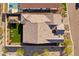 Aerial roof-top view of a home with desert landscaping and artificial turf at 21391 W Mariposa St, Buckeye, AZ 85396