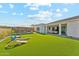 Expansive backyard features lush artificial turf, a charming pergola, and a playful swing set under a sunny sky at 21391 W Mariposa St, Buckeye, AZ 85396