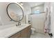 Stylish bathroom with a round mirror, ample counter space, and sleek fixtures at 21391 W Mariposa St, Buckeye, AZ 85396