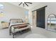 Stylish bedroom includes a decorative bed frame, bench, and sliding barn door detail at 21391 W Mariposa St, Buckeye, AZ 85396