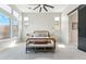 Bright bedroom features large windows, neutral color palette, and sliding barn door to the bathroom at 21391 W Mariposa St, Buckeye, AZ 85396