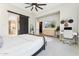 Bedroom features desk, decor, and sliding barn door to bathroom at 21391 W Mariposa St, Buckeye, AZ 85396