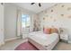 Adorable bedroom with flower decals, pink accents, and a comfortable bed at 21391 W Mariposa St, Buckeye, AZ 85396