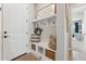 Bright entryway features a bench with hooks and storage baskets, perfect for organization and a welcoming feel at 21391 W Mariposa St, Buckeye, AZ 85396