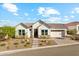 Beautifully landscaped single-Gathering home with a manicured front yard, stone accents, and a two car garage at 21391 W Mariposa St, Buckeye, AZ 85396