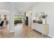 Spacious foyer with light wood floors, modern console table, and an open layout leading to the living and dining areas at 21391 W Mariposa St, Buckeye, AZ 85396