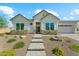 Charming single-Gathering home with board and batten siding, desert landscaping, and a welcoming walkway leading to the front door at 21391 W Mariposa St, Buckeye, AZ 85396