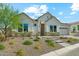 Charming single-Gathering home featuring stone accents, a well-manicured front yard, and a welcoming entrance at 21391 W Mariposa St, Buckeye, AZ 85396
