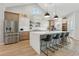 Bright kitchen features an island with seating, stainless steel appliances, and a pantry at 21391 W Mariposa St, Buckeye, AZ 85396