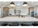 A bright, modern kitchen with an oversized island and pendant lighting at 21391 W Mariposa St, Buckeye, AZ 85396