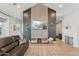 Cozy living room with a fireplace, a TV, and plenty of natural light at 21391 W Mariposa St, Buckeye, AZ 85396