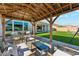 Inviting covered patio with comfortable seating and a well-manicured lawn creating an outdoor living space at 21391 W Mariposa St, Buckeye, AZ 85396