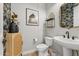 Chic powder room features unique decor, stylish fixtures, and a modern vanity at 21391 W Mariposa St, Buckeye, AZ 85396