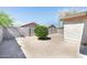 Backyard features a privacy wall and a tree for shade at 2174 W Kristina Ave, San Tan Valley, AZ 85144