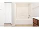 Bathroom with a combination tub and shower with white tile surround at 2174 W Kristina Ave, San Tan Valley, AZ 85144