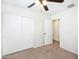 Bright bedroom featuring neutral carpet, a ceiling fan, and closet with sliding doors at 2174 W Kristina Ave, San Tan Valley, AZ 85144