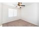 Bright bedroom with neutral carpet, a ceiling fan, and a window with blinds at 2174 W Kristina Ave, San Tan Valley, AZ 85144