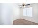 Bright bedroom featuring neutral carpet, a ceiling fan, and a window with blinds at 2174 W Kristina Ave, San Tan Valley, AZ 85144