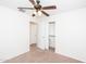 Bright bedroom featuring neutral carpet, a ceiling fan, and closet with sliding doors at 2174 W Kristina Ave, San Tan Valley, AZ 85144