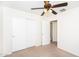 Bright bedroom featuring neutral carpet, a ceiling fan, and closet with sliding doors at 2174 W Kristina Ave, San Tan Valley, AZ 85144