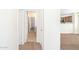 Neutral hallway leads to kitchen with stainless steel appliances at 2174 W Kristina Ave, San Tan Valley, AZ 85144