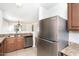 Kitchen with stainless steel refrigerator, granite countertops and tile floors at 2174 W Kristina Ave, San Tan Valley, AZ 85144