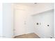 Functional laundry room with tiled floor, shelf, and utility hook-ups at 2174 W Kristina Ave, San Tan Valley, AZ 85144