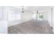 Expansive living room featuring neutral carpet, slider door to backyard, and ample lighting at 2174 W Kristina Ave, San Tan Valley, AZ 85144