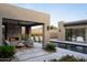 Backyard featuring a covered patio, water feature, and desert landscaping, perfect for entertaining at 24863 N 103Rd Way, Scottsdale, AZ 85255