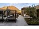 Modern backyard with sleek lounge chairs, a unique water feature, and desert mountain views at 24863 N 103Rd Way, Scottsdale, AZ 85255
