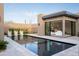Elegant backyard featuring a sleek pool, desert landscaping, and seamless bedroom access at 24863 N 103Rd Way, Scottsdale, AZ 85255