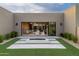 Elegant backyard patio featuring a fire pit and seamless indoor-outdoor living with large sliding glass doors at 24863 N 103Rd Way, Scottsdale, AZ 85255