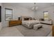Bright bedroom featuring neutral decor, a large bed, and a cozy seating area at 24863 N 103Rd Way, Scottsdale, AZ 85255