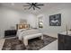 Modern bedroom with a ceiling fan, a neutral color palette, and a dark patterned rug at 24863 N 103Rd Way, Scottsdale, AZ 85255