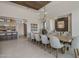 Dining room with a large wooden table, seating for ten, and a modern light fixture in an open concept space at 24863 N 103Rd Way, Scottsdale, AZ 85255
