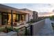 Modern home exterior with stone accents, covered patio, and well-manicured landscaping at 24863 N 103Rd Way, Scottsdale, AZ 85255