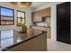 Kitchen area with stylish cabinets, modern appliances, and an island with countertop at 24863 N 103Rd Way, Scottsdale, AZ 85255