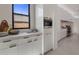 Kitchen featuring white cabinets, integrated stainless steel appliances, quartz countertops, and marble backsplash at 24863 N 103Rd Way, Scottsdale, AZ 85255