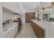 Bright kitchen featuring modern appliances, quartz countertops, marble backsplash and white and wood cabinets at 24863 N 103Rd Way, Scottsdale, AZ 85255