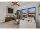Contemporary living room with a designer light fixture, modern decor, and expansive windows at 24863 N 103Rd Way, Scottsdale, AZ 85255