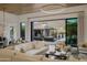 Open-concept living area with modern decor, statement lighting, and sliding glass doors to the backyard at 24863 N 103Rd Way, Scottsdale, AZ 85255