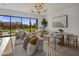 Bright living room featuring modern furniture, stylish lighting, and large windows with desert views at 24863 N 103Rd Way, Scottsdale, AZ 85255