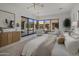 Serene main bedroom with natural light, stylish decor, and views of a private courtyard with seating at 24863 N 103Rd Way, Scottsdale, AZ 85255
