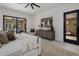 Well-lit main bedroom with an outdoor access, ceiling fan and modern art at 24863 N 103Rd Way, Scottsdale, AZ 85255